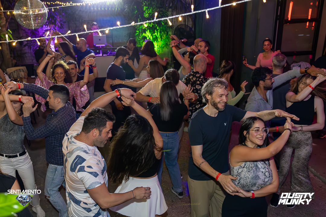 Salsa rueda circle with dancers spinning together