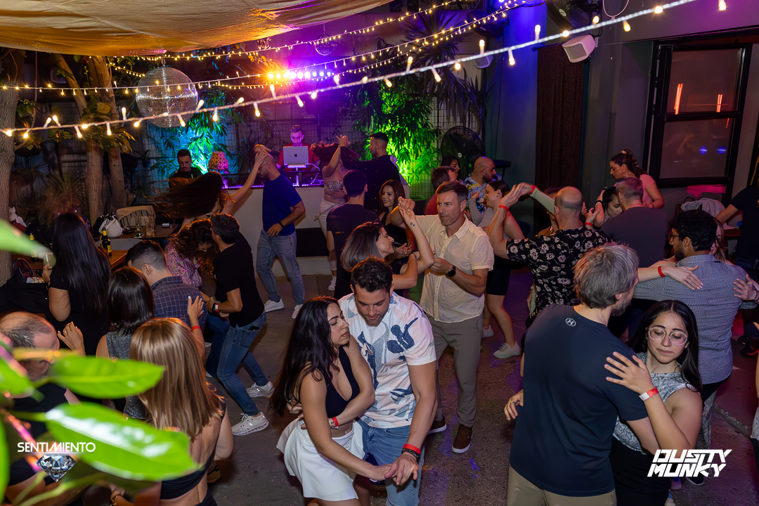 Packed dance floor under the disco ball and fairy lights